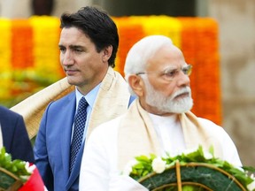 Canadian Prime Minister Justin Trudeau (left) walks past Indian Prime Minister Narendra Modi as they take part in a wreath-laying ceremony at Raj Ghat, Mahatma Gandhi's cremation site, during the G20 Summit in New Delhi, Sunday, Sept. 10, 2023.