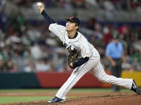 FILE - Japan's Yoshinobu Yamamoto delivers a pitch during the fifth inning of a World Baseball Classic game against Mexico on March 20, 2023, in Miami. Yamamoto, the most prized pitcher on the free-agent market, has agreed to a $325 million, 12-year contract with the Los Angeles Dodgers, according to multiple reports.