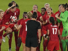 Canada players including Christine Sinclair (holding ball)celebrate their win against Sweden during the women's soccer gold medal game at the Tokyo Olympics in Yokohama, Japan on Friday, August 6, 2021.
