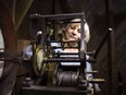 Expert Watchmaker, Liudmyla Pass, who recently arrived in Newfoundland and Labrador from the Ukraine makes an adjustment to the timing on the 1905 clock in the old Clock Tower of the old Post Office on Water Street in Carbonear, N.L., Friday, Dec. 22, 2023.