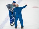 Coach Rick Tocchet talks with Brock Boeser during practice last month.