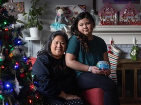Emily Patterson and her daughter Audrey, 9, holding a gift she made for her mom, at their home in North Vancouver on Dec. 15.