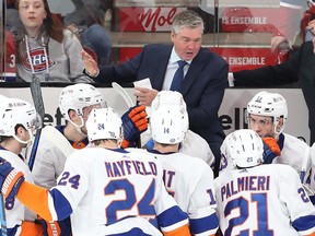Islanders coach Patrick Roy talks to his players during first-period stop in the action Thursday night at the Bell Centre.