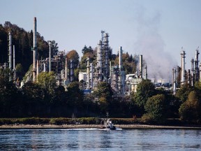 A boat sails past the Burnaby Refinery, operated by Parkland Fuel Corp., in Burnaby, British Columbia, Canada, on Wednesday, Sept. 19, 2018.