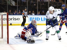 Brock Boeser gets the puck past Igor Shesterkin of the New York Rangers to score a goal during the first period at Madison Square Garden on January 08, 2024 in New York City.