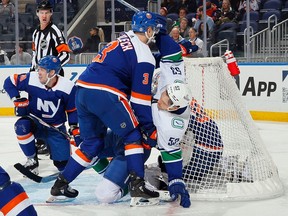 Adam Pelech of the New York Islanders checks Teddy Blueger #53 of the Vancouver Canucks in the crease during the first period at UBS Arena on January 09, 2024 in Elmont, New York.