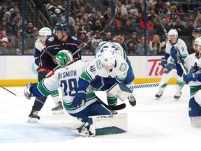 Elias Pettersson ollides into Casey DeSmith during the second period against the Columbus Blue Jackets at Nationwide Arena on January 15, 2024 in Columbus, Ohio.