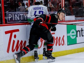 Ottawa Senators left winger Brady Tkachuk (7) checks Vancouver Canucks defenceman Quinn Hughes (43) at the Canadian Tire Centre in April, 2021.