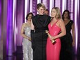 This image released by CBS shows co-director Greta Gerwig, left, and actor Margot Robbie accepting the award for best cinematic and box office achievement for the film "Barbie" during the 81st Annual Golden Globe Awards in Beverly Hills, Calif., on Sunday, Jan. 7, 2024.