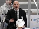 Vancouver Canucks coach Rick Tocchet gives instructions to J.T. Miller (9) and others during overtime period of the team's NHL hockey game against the Pittsburgh Penguins in Pittsburgh, Thursday, Jan. 11, 2024.