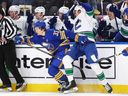 Canucks winger Dakota Joshua slams Sabres defenceman Ryan Johnson into boards Saturday during gritty battle in which Vancouver prevailed 1-0.
