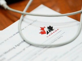 A Hockey Canada document is reviewed by a member of Parliament during a House of Commons Committee in 2022.