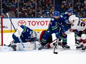 Vancouver Canucks goaltender Thatcher Demko (35) stops Ottawa Senators Erik Brannstrom (26) as Vancouver's Filip Hronek (17) and Quinn Hughes (43) watch during the second period on Tuesday night at Rogers Arena.
