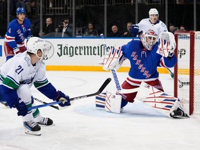 New York Rangers goaltender Igor Shesterkin (31) reacts after a puck shot past him from Vancouver Canucks' Nils Hoglander (21) for a goal during the first period of an NHL hockey game Monday, Jan. 8, 2024, in New York.