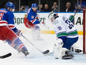 Vancouver Canucks goaltender Thatcher Demko (35) stops a shot by New York Rangers' Jacob Trouba (8) during the second period in New York.