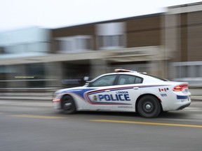 A police car drives by London Police Headquarters in London, Ont., Monday, Jan. 29, 2024.