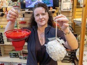Sonia Henriques, a certified bird feeding specialist at Wild Birds Unlimited Nature Shop in Vancouver, with a hummingbird feeder warmer known as a Hummingbird Hearth, and hummingbird nesting material on Tuesday.