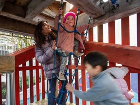 New recommendations from the Canadian Paediatric Society find benefits in "risky play." In a file photo, Layla Humayun, 10, (left) helps cousin Francesca Fumano, 2, climb a rope ladder at Rainbow Park in Vancouver.