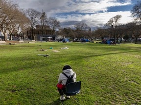 Carlos Hernandez sits alone in a chair after police and park rangers force local homeless to pack up their tents at Oppenheimer Park.