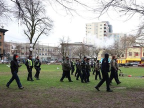 Vancouver police and Park Rangers move campers from Oppenheimer Park on Wednesday.