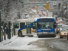 A bus is stuck on Broadway near Manitoba as people and traffic brave a snowstorm in Vancouver on Feb. 3, 2017.