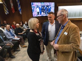 Vancouver Councillor Adriane Carr talks with Brennan Bastyovanszky and Tom Digby prior to the parks board meeting with council in Vancouver on December 11, 2023.