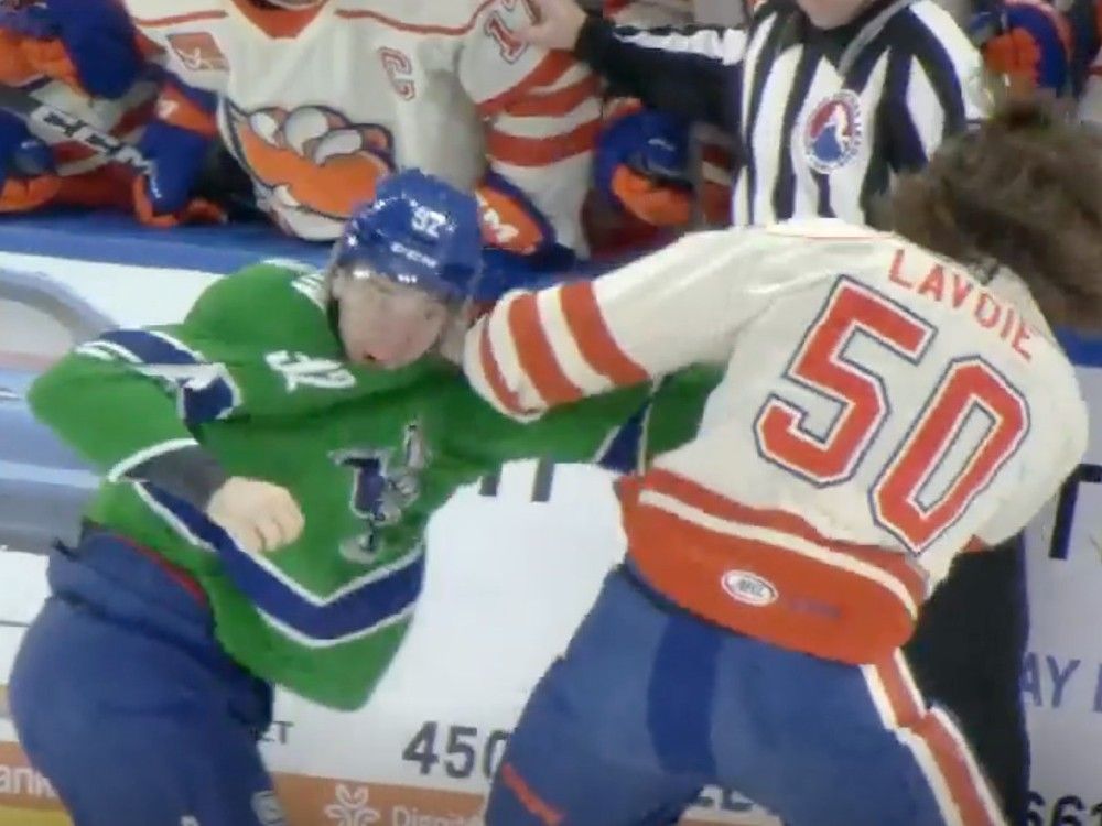 Abbotsford Canucks forward Vasily Podkolzin fights Bakersfield Condors forward Raphael Lavoie on Saturday night in an AHL game in Bakersfield. Abbotsford won 3-2 in overtime.