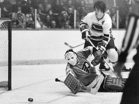 Vancouver Canucks Dale Tallon watches in vain as Philadelphia goalie Bruce Gamble deflects a shot away in 1972.