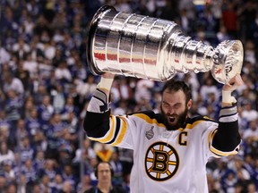 Zdeno Chara lifting the Stanley Cup on Vancouver's home ice.