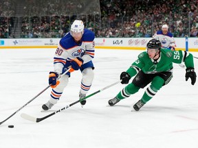 DALLAS, TEXAS - FEBRUARY 17: Corey Perry #90 of the Edmonton Oilers is defended by Thomas Harley #55 of the Dallas Stars during the second period at American Airlines Center on February 17, 2024 in Dallas, Texas.