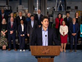 Prime Minister Justin Trudeau, joined by members of the Liberal Cabinet, speaks to the media at the McMaster Automotive Resource Centre, in Hamilton, Ont., during the final day of meetings at the Liberal Cabinet retreat, on Jan. 25, 2023.