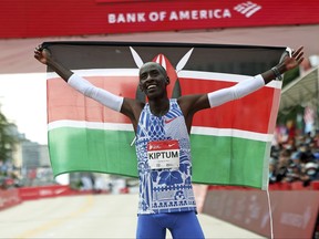 Kelvin Kiptum of Kenya celebrates his Chicago Marathon world record victory in Chicago's Grant Park on Sunday, Oct. 8, 2023.