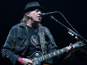 (FILES) In this file photo taken on July 06, 2018 Neil Young performs on stage for his first time in Quebec City during 2018 Festival d'Ete. - As the coronavirus pandemic hits indefinite pause on concerts and touring, many musicians are instead streaming shows for tens of thousands of fans self-quarantining. Artists including Neil Young, Chris Martin of Coldplay and Christine and the Queens are among those who have played online shows for the folks at home, as governments worldwide ban mass gatherings and urge people to hunker down. (Photo by Alice Chiche / AFP)