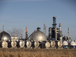 Storage tanks and trucks at the Imperial refinery in Edmonton, Alberta. Canadian oil producers expect to garner better prices for their crude when the expanded Trans Mountain expansion starts up.