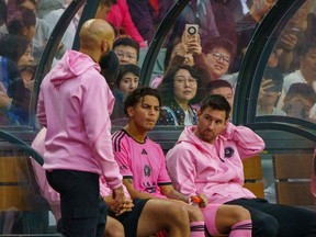 Lionel Messi, right, on the bench during the Inter Miami match in Hong Kong.
