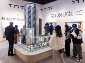 Potential buyers gather information at the Juno sales centre on 104th Avenue in Surrey on Feb. 7. The Juno will be a highrise condo development that includes eight three-bedroom suites that include a lock-off suite.
