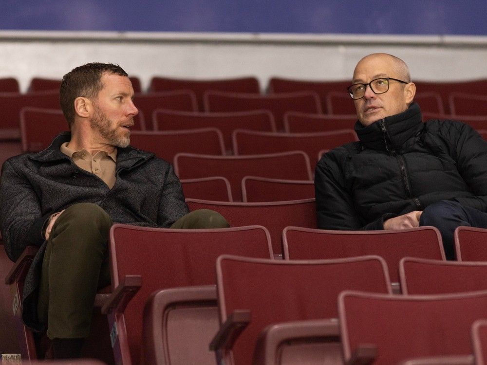 Vancouver Canucks assistant to the general manager Ryan Johnson and Vancouver Canucks general manager Patrik Allvin watch Canucks practice at Rogers Arena Jan. 17, 2024. 
