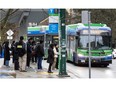 People wait to board buses at Joyce-Collingwood Station in Vancouver on Feb. 20.