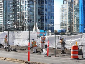 Construction workers on the Granville Street Bridge on Feb, 26, 2024.