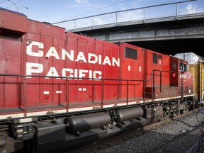 A Canadian Pacific Railway locomotive passes under a bridge in Calgary. Two railway crew members were sent to hospital after multiple locomotives derailed and sparked a fire east of Revelstoke.