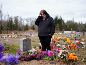 Evelyn Jefferson, a crisis outreach supervisor for Lummi Nation, stands at the grave of her son Patrick George Jr., who died last September due to an overdose of street drugs containing the synthetic opioid carfentanil, at the Lummi Nation cemetery on tribal reservation lands, Thursday, Feb. 8, 2024, near Bellingham, Wash. Jefferson had to wait a week to bury her son due to several other overdose deaths in the community.