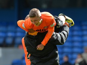 A youthful Ryan Gauld of Dundee United is carried from the pitch after a big win.