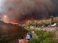 Residents watch the McDougall Creek wildfire in West Kelowna, British Columbia, Canada, on August 17, 2023, from Kelowna.