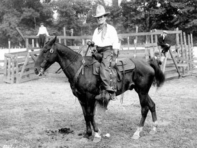 A.D. (Cowboy) Kean on horseback at the PNE rodeo on Aug. 18. 1923. Kean is riding a horse during the PNE's Range Days event that he managed. Kean's name is spelled out on his leather chaps. He directed the first film made in B.C. by a British Columbian, Policing the Plains, between 1924 and 27.