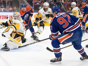Pittsburg Penguins goalie Alex Nedeljkovic (39) makes a save on Edmonton Oilers' Connor McDavid (97) during second period NHL action in Edmonton on Sunday, March 3, 2024.