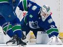 Canucks goaltender Thatcher Demko covers up the puck Saturday before being injured in the second period of a 5-0 win over the Jets at Rogers Arena.