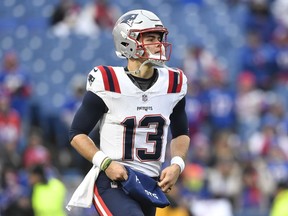 New England Patriots quarterback Nathan Rourke (13) warms up before an NFL football game against the Buffalo Bills in Orchard Park, N.Y., on December 31, 2023.