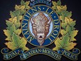 The RCMP logo is seen outside Royal Canadian Mounted Police "E" Division Headquarters, in Surrey, B.C., on Friday April 13, 2018. Mounties in Kelowna, B.C., are investigating after two bodies were found in a business following gunshots and a fire.