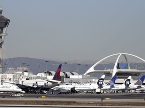 Airplanes sit on the tarmac at Los Angeles International Airport Friday, Nov. 1, 2013.