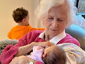 Miriam Macdougall welcomes Daisy, her second great-grandchild, while Miles plays in the background.